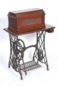 A late 19th century Victorian sewing machine and treadle table. The sewing machine base being