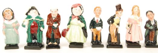 A group of eight Royal Doulton Dickensian figurines to include Bumble , Scrooge , Mrs Bardell ,