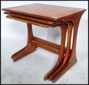 A set of three vintage 20th century Danish influence teak nest of tables in the manner of G-Plan.