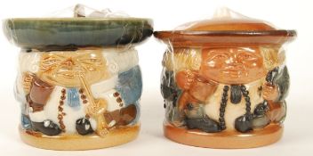Two Doulton Lambeth Toby Jug wares , a sealed lidded tobacco jar and a lidded biscuit barrel.
