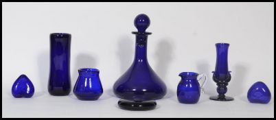 A collection of 20th century Bristol Blue glass items to include a ships decanter, 2 hearts, 2