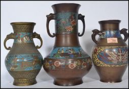 A group of three 20th century Chinese cloisonne vases having mythical creature handles. Highest