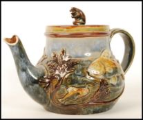 A Royal Doulton stoneware teapot and cover, the design attributed to George Tinworth, the body