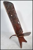 An early 20th century African Kenyan hardwood birthing chair comprised of two parts with carved