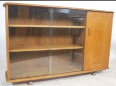 A mid century oak display cabinet bookcase room divider in the manner of Ercol, believed to be