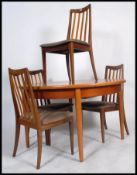 A stunning 20th century G-Plan teak extending dining table. Raised on tapered support with pierced