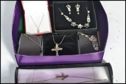 A group of vintage silver necklaces and pendants to include crucifix , flowers , white stone , heart