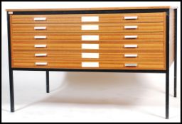 A retro 1970's architects teak wood affect plan chest of six drawers, slab top raised on square