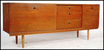A mid century retro teak wood sideboard by Avalon, central bank of three drawers flanked by