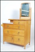 A 1930's Waring & Gillows solid oak and marble dressing table / chest of drawers having an