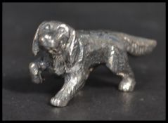 A sterling silver figurine in the form of a dog. Weighs 12 grams.