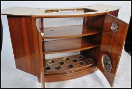 A vintage retro 20th century walnut bar cocktail cabinet by Turnidge of London having a fold out