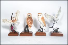 A group of four highly detailed still life models of owls to include barn owl , tawny owl etc. All
