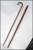 A silver white metal mounted walking stick cane having makers stamp WKC along with an applied bark