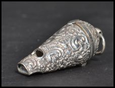A sterling silver vinaigrette in the form of a  whistle having an embossed decoration. Weighs 36