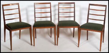 A set of four retro 20th century / 1970's teak wood rail back dining chairs having  vinyl seat