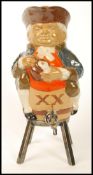 A Doulton Lambeth Toby XX spirit decanter modelled as a Toby seated on a barrel, with silver