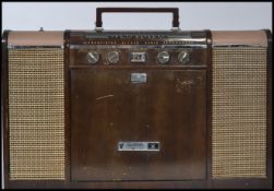 A vintage mid 20th century Crown V stereo 12 transistor stereo radio phonograph record player.