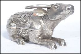 A Chinese silver lidded pot in the form of an Ox / Cow modelled in a seated position having a