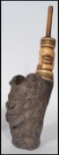 A 19th century African smoking pipe. The bowl carved in the form of a grotesque figure. Measures