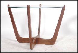 A 1970's / mid 20th century Danish inspired teak wood and glass atomic coffee table. The good teak