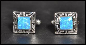 A pair of sterling silver and opallite panel cuff links of square form having pierced sides and T