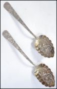 A pair of 19th century Chinese silver serving spoons having an engraved design with embossed dragons