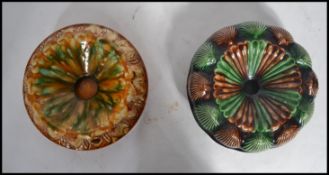 2 19th century Majolica drip glazed spittoons, both of circular form , one with shell decoration.