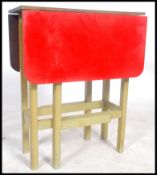 A mid century retro red formica and painted drop leaf kitchen side dining table. The red formica