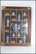A vintage 20th century antique style framed and glazed display of miniature Chinese wares to include