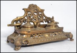A Victorian 19th century cast brass desk tidy inkwell having twin wells with gallery back, the whole