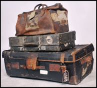 A collection of early 20th century luggage to include a large canvas and leather bound trunk,
