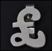 A sterling silver money clip in the form of a pound sign. Weighs 20 grams.
