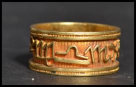 An Egyptian 18ct gold band ring having the Zodiac symbols around the band. Weighs 8.6 grams size