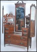 An Edwardian walnut drop centre bat wing dressing table. Raised on turned legs with castors having a