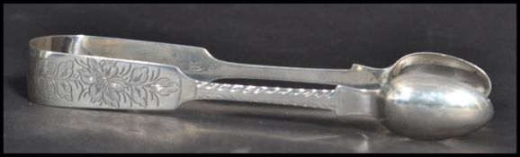 A pair of 19th century Victorian sugar tongs bearing hallmarks for Exeter 1847 makers Robert and