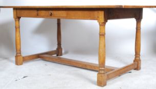 A large 20th century good quality country oak refectory dining table being raised on turned legs