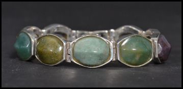 A sterling silver panel bracelet set with agates having a fold over clasp. Weighs 50 grams.
