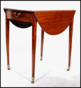 An early 20th century Edwardian mahogany occasional drop leaf table, raised on square tapering