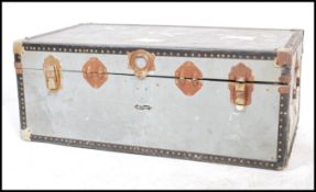 A vintage retro 20th century industrial storage steamer trunk having brass bound and lock.