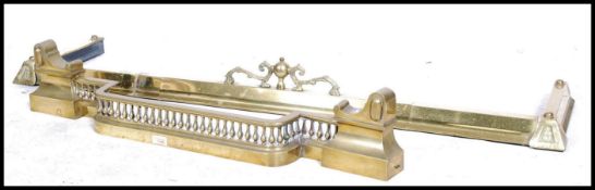 Two late 19th century / early 20th century brass fire fenders one being adjustable with a gallery