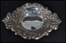 A 20th century silver hallmarked rococo style pin tray having scrolled and acanthus leaf decoration.
