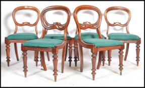 A set of six 19th century Victorian mahogany balloon back dining chairs having overstuffed seats