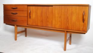 A Danish inspired 1960's retro teak wood sideboard having three drawers adjacent to a twin sliding
