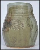 A 20th century studio pottery vase in the manner of Martin Brothers depicting a grotesque football