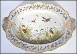 A 19th century ceramic platter meat tray depicting swans and cranes with insects. Floral sprays with