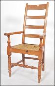 A 19th century Victorian  walnut ladderback  armchair being raised on turned legs united by
