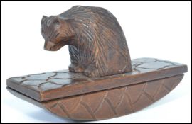 A 19th century Blackforest carved blotter in the form of a bear with shaped blotter base. Measures