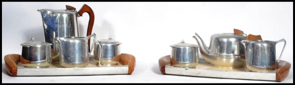 A vintage Picquot ware mid century stainless steel and teak wood service comprising 2 trays,