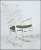 A vintage retro 1970's danish inspired ladder back rocking chair constructed from beech wood with